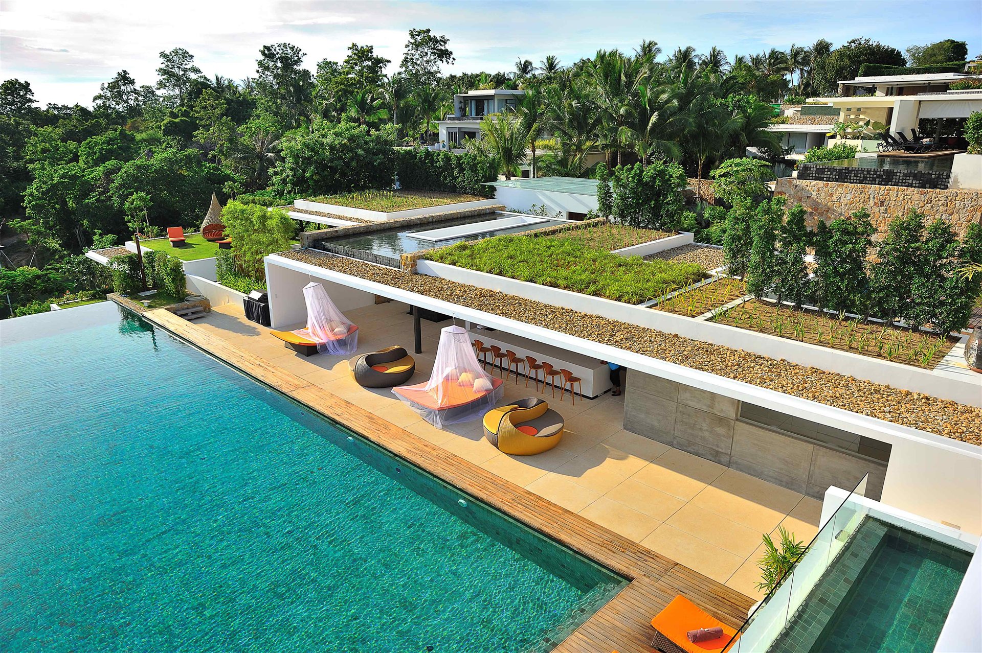 Large infinity pool and green-roof villa