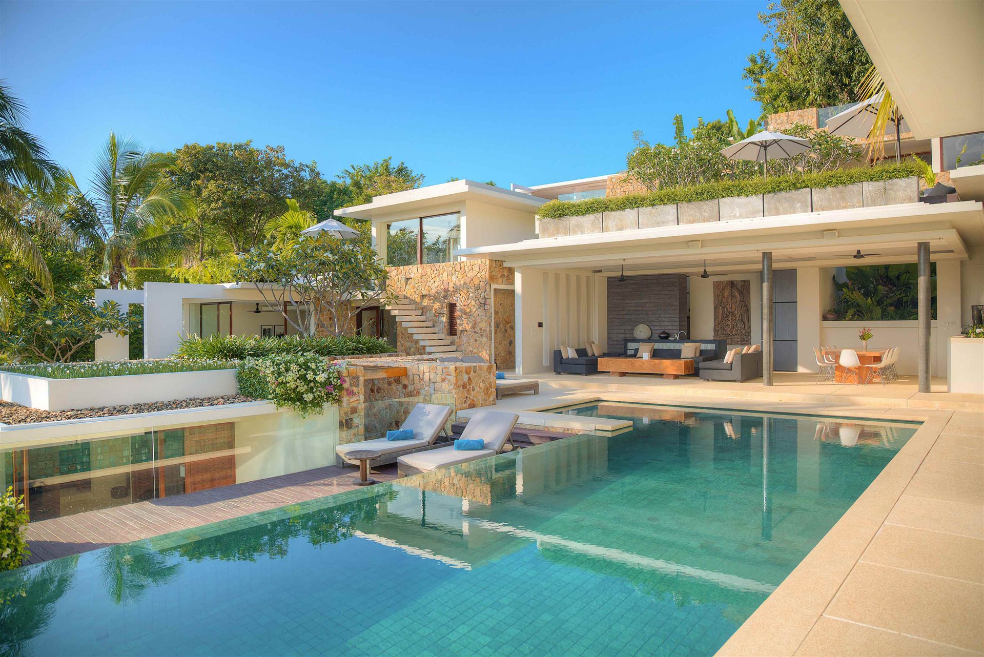 Terraced tropical villa surrounding an infinity pool