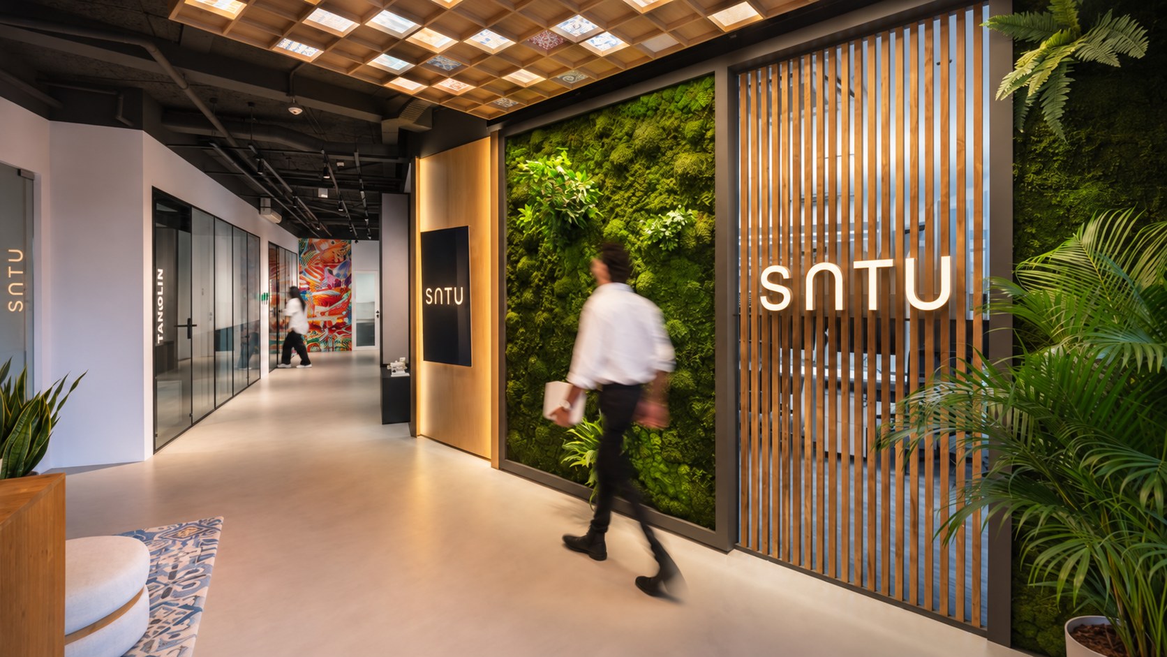 SATU design studio with tropical planting and illuminated identity